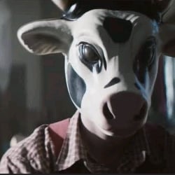 MAN WITH COW MASK